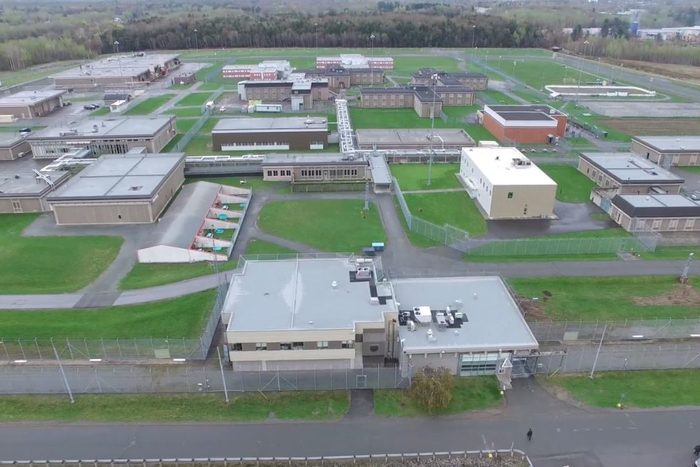 Aerial view of the Donnacona Correctional Complex, showing secure buildings, perimeter fences, and outdoor facilities on a large green property